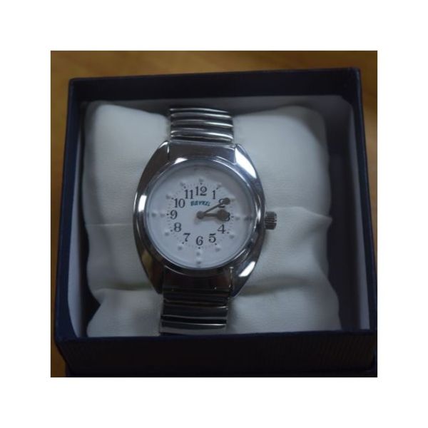 A quartz, tactile watch that is a silver-tone, 3/4-inch face, bezel, and expansion band in a box. 